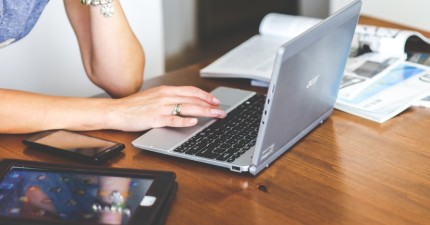 woman-hand-smartphone-laptop-large