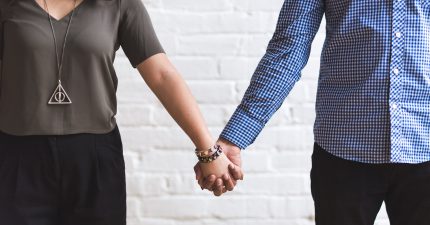 man and woman holding hands